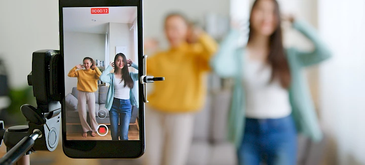 Junge Erwachsene bei der Aufnahme eines TikTok-Videos